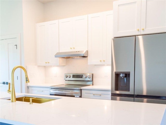14073 Naylor Ave, Port Charlotte, FL 33981 - kitchen featuring appliances with stainless steel finishes, under cabinet range hood, and white cabinets