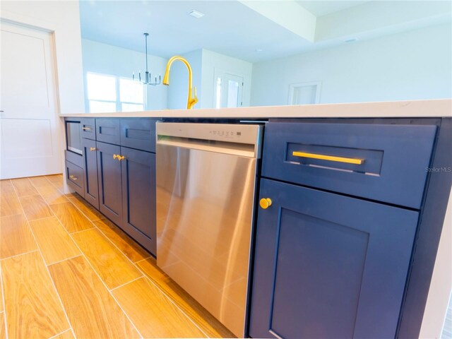 14073 Naylor Ave, Port Charlotte, FL 33981 - kitchen with stainless steel dishwasher, pendant lighting, light countertops, a chandelier, and wood finish floors