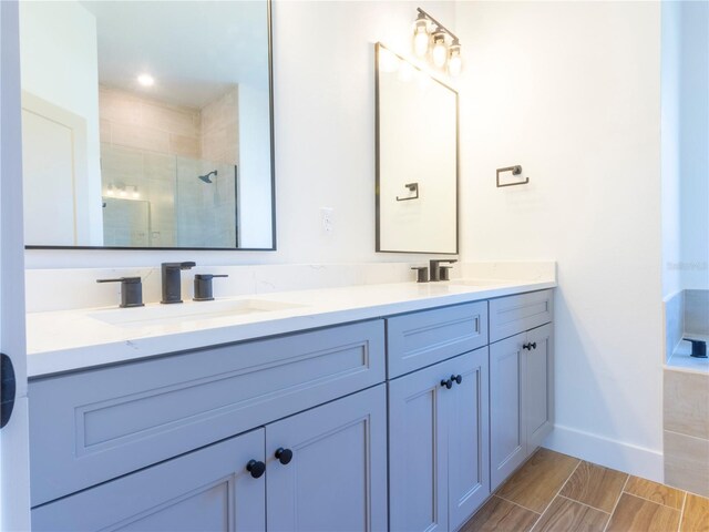 14073 Naylor Ave, Port Charlotte, FL 33981 - bathroom with double vanity, tiled shower, and wood finish floors