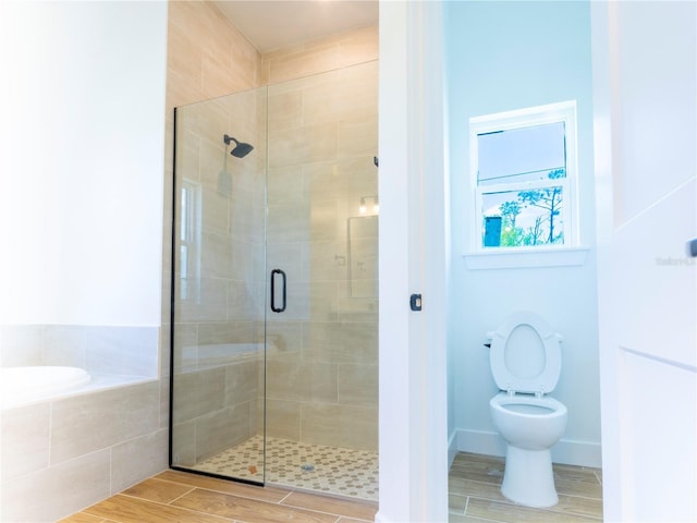 14073 Naylor Ave, Port Charlotte, FL 33981 - bathroom featuring a stall shower, a bath, and wood finished floors