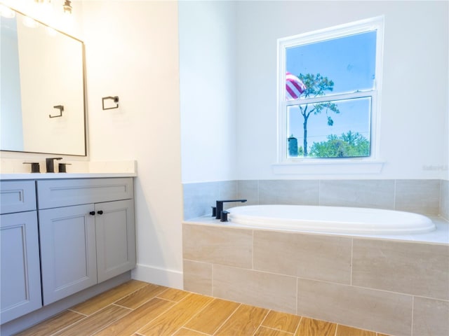 14073 Naylor Ave, Port Charlotte, FL 33981 - bathroom featuring vanity, a garden tub, and wood finished floors