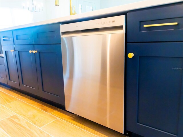 14073 Naylor Ave, Port Charlotte, FL 33981 - kitchen with dishwasher, blue cabinets, and a chandelier