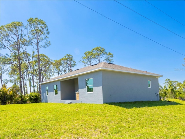 14073 Naylor Ave, Port Charlotte, FL 33981 - back of house featuring stucco siding and a yard