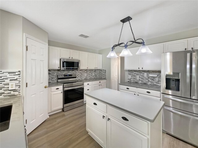 4209 SW 33rd St, Ocala, FL 34474 - kitchen with stainless steel appliances, tasteful backsplash, and light wood finished floors
