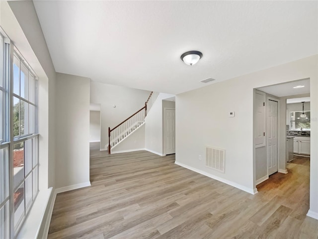 4209 SW 33rd St, Ocala, FL 34474 - spare room featuring light wood-style floors and stairway