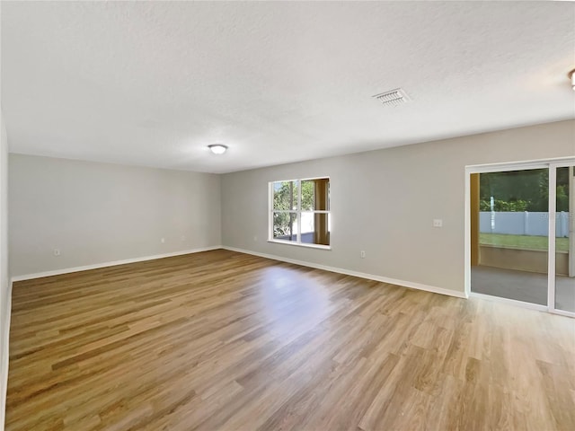 4209 SW 33rd St, Ocala, FL 34474 - empty room with light wood-style floors and a textured ceiling