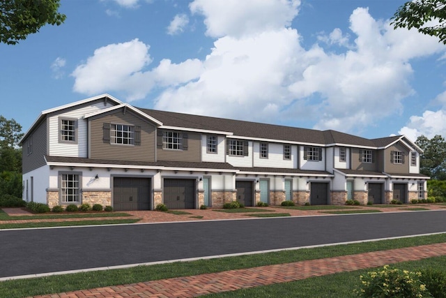 4224 Campsite Loop, Orlando, FL 32824 - townhome / multi-family property featuring stone siding, a garage, and driveway