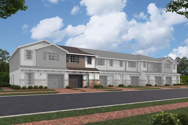 4224 Campsite Loop, Orlando, FL 32824 - view of front facade featuring stone siding, an attached garage, and driveway