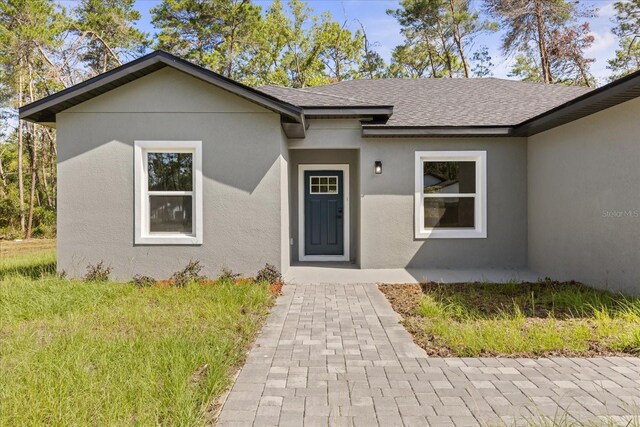 17445 SW 41st Cir, Ocala, FL 34473 - entrance to property with a shingled roof and stucco siding