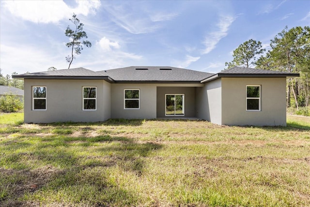 17445 SW 41st Cir, Ocala, FL 34473 - rear view of property with stucco siding, a yard, and roof with shingles