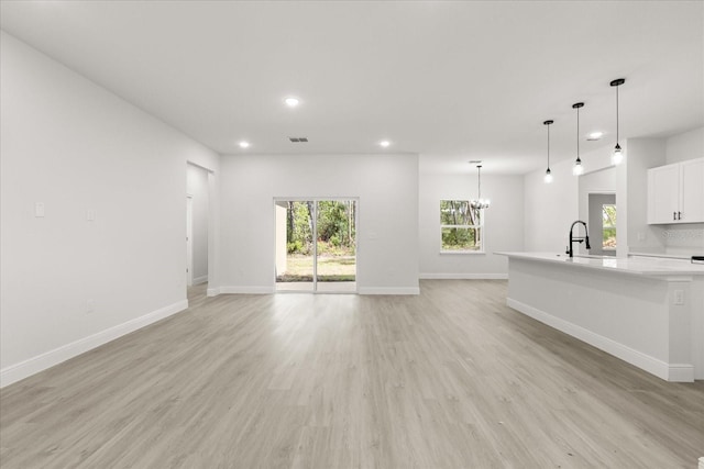 17445 SW 41st Cir, Ocala, FL 34473 - unfurnished living room featuring recessed lighting, a chandelier, and light wood finished floors
