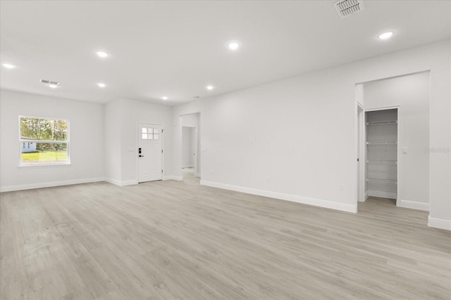 17445 SW 41st Cir, Ocala, FL 34473 - unfurnished living room with light wood-style floors and recessed lighting