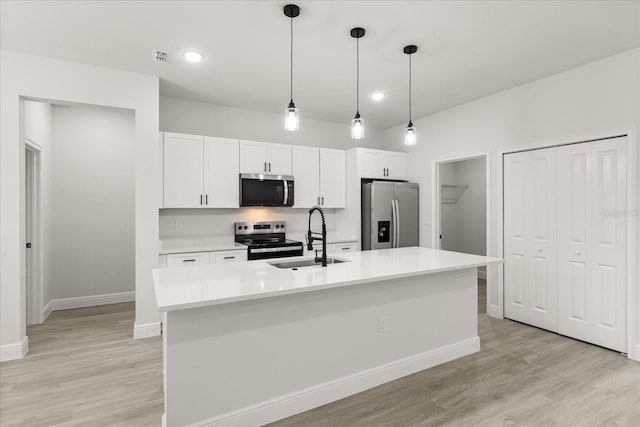 17445 SW 41st Cir, Ocala, FL 34473 - kitchen featuring stainless steel appliances, white cabinetry, light countertops, light wood finished floors, and recessed lighting