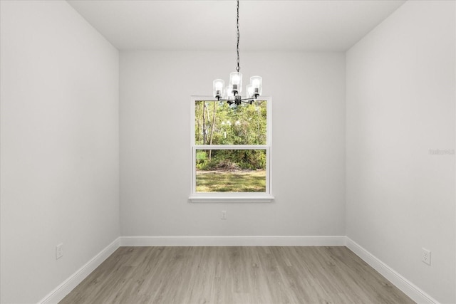 17445 SW 41st Cir, Ocala, FL 34473 - spare room with a chandelier and light wood finished floors