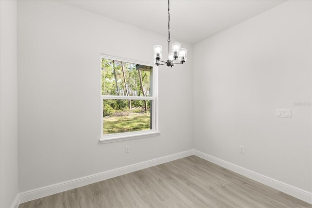 17445 SW 41st Cir, Ocala, FL 34473 - unfurnished room featuring a chandelier and light wood-style floors