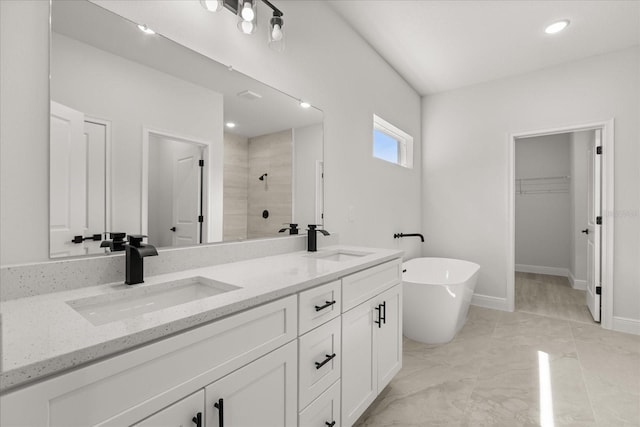 17445 SW 41st Cir, Ocala, FL 34473 - bathroom featuring tiled shower, double vanity, a freestanding bath, a walk in closet, and marble finish flooring