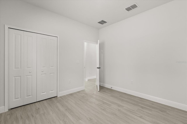 17445 SW 41st Cir, Ocala, FL 34473 - unfurnished bedroom with light wood finished floors and a closet