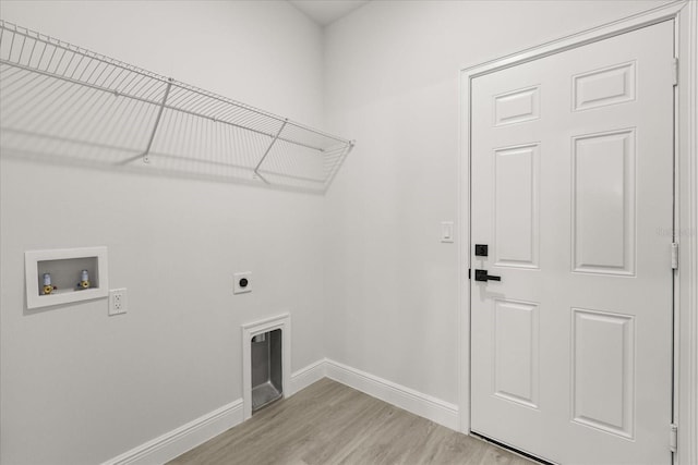 17445 SW 41st Cir, Ocala, FL 34473 - laundry room featuring hookup for an electric dryer, hookup for a washing machine, and light wood finished floors