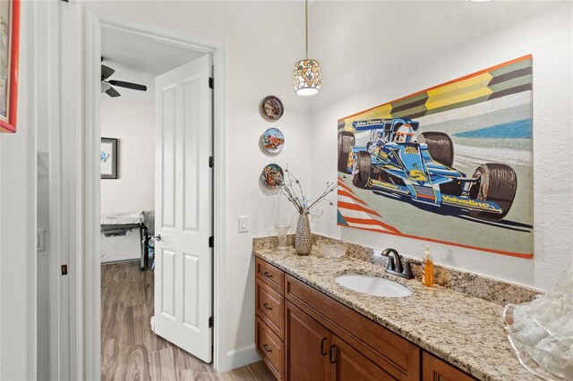 13023 Sweet Hill Rd, Polk City, FL 33868 - bathroom with wood finished floors, vanity, and ceiling fan
