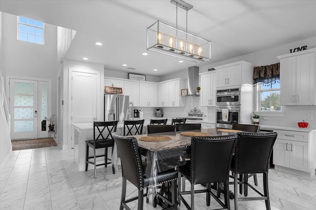 7454 Gathering Dr, Reunion, FL 34747 - dining space with light marble finish floors and recessed lighting