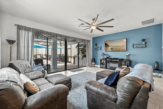 7454 Gathering Dr, Reunion, FL 34747 - living area featuring ceiling fan and baseboards