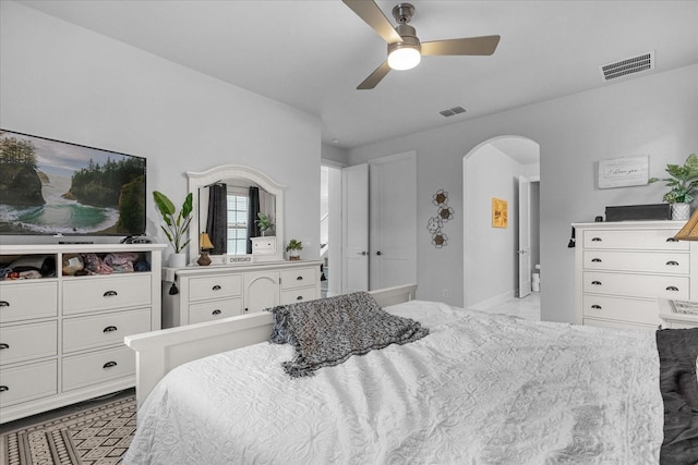 7454 Gathering Dr, Reunion, FL 34747 - bedroom with arched walkways and a ceiling fan