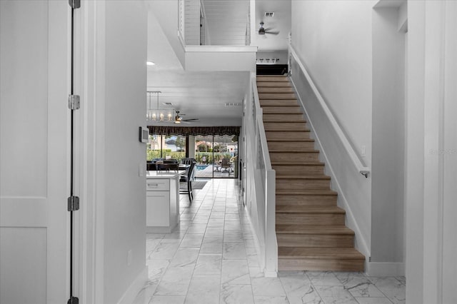 7454 Gathering Dr, Reunion, FL 34747 - staircase featuring a ceiling fan, marble finish floors, and recessed lighting