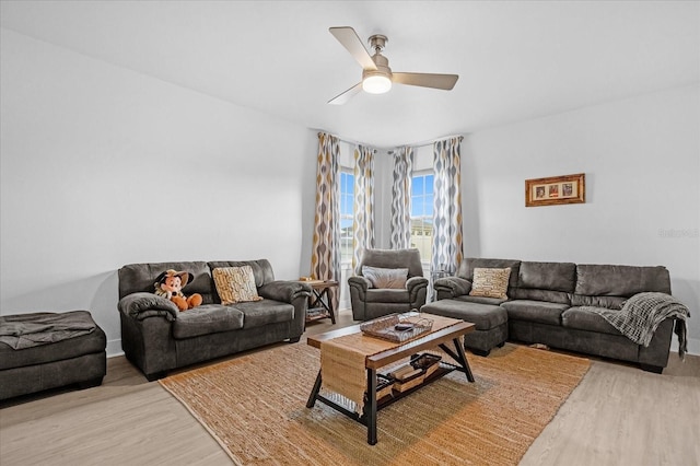 7454 Gathering Dr, Reunion, FL 34747 - living area featuring light wood finished floors and ceiling fan