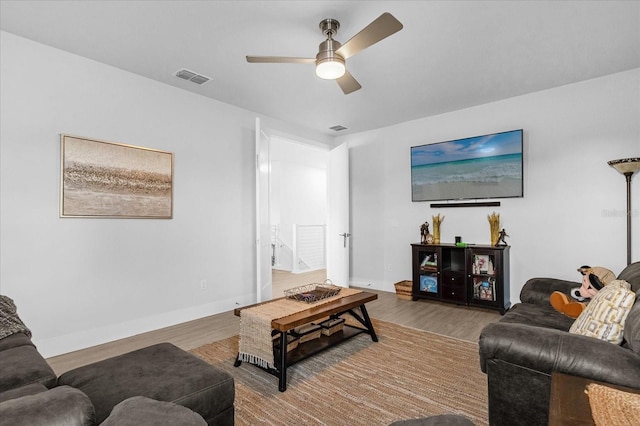 7454 Gathering Dr, Reunion, FL 34747 - living area featuring a ceiling fan and wood finished floors