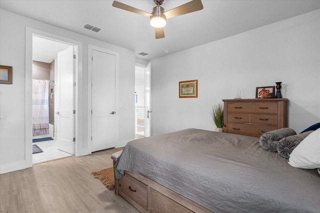 7454 Gathering Dr, Reunion, FL 34747 - bedroom featuring light wood-style floors, ceiling fan, and ensuite bath