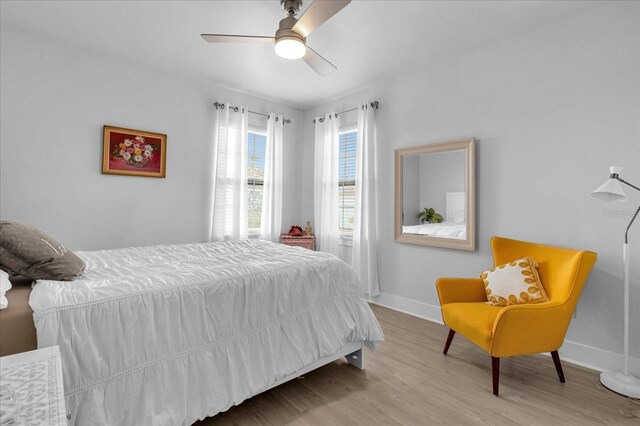7454 Gathering Dr, Reunion, FL 34747 - bedroom with wood finished floors and a ceiling fan