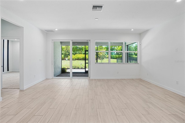 11687 SW Viridian Blvd, Port St Lucie, FL 34987 - empty room with healthy amount of natural light, light wood finished floors, and recessed lighting