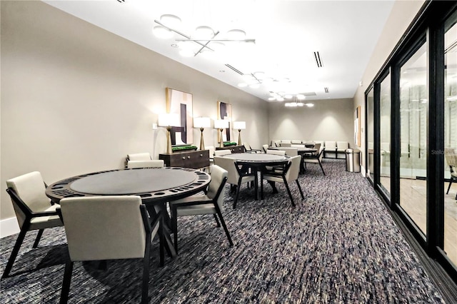 11687 SW Viridian Blvd, Port St Lucie, FL 34987 - carpeted dining area featuring a chandelier