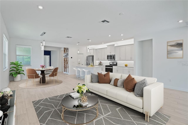 11687 SW Viridian Blvd, Port St Lucie, FL 34987 - living area featuring light wood finished floors and recessed lighting