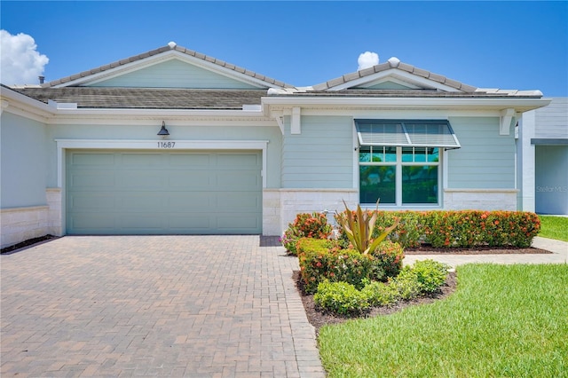 11687 SW Viridian Blvd, Port St Lucie, FL 34987 - single story home featuring decorative driveway, a garage, and a tile roof