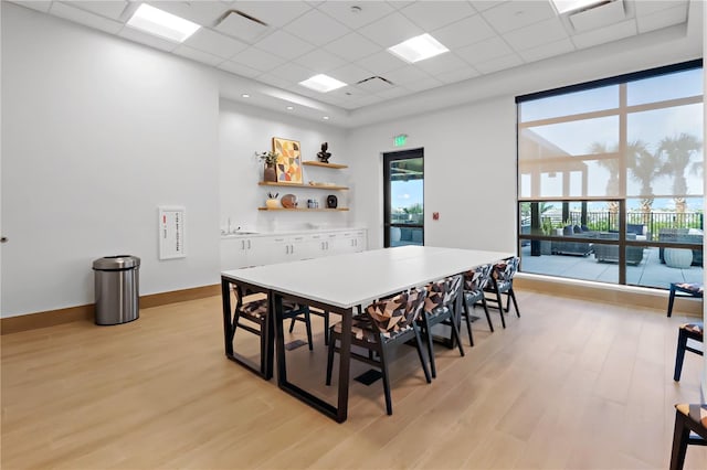 11687 SW Viridian Blvd, Port St Lucie, FL 34987 - dining area with light wood-style flooring and a paneled ceiling