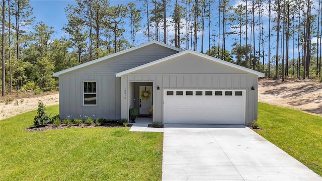 13264 SW 69th Pl, Ocala, FL 34481 - view of front facade featuring board and batten siding, driveway, a garage, and a front yard