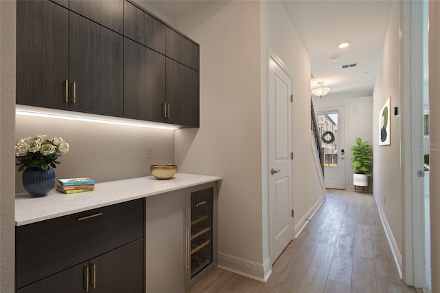8484 Sperry St, Orlando, FL 32827 - hallway with light wood-style flooring, beverage cooler, and recessed lighting