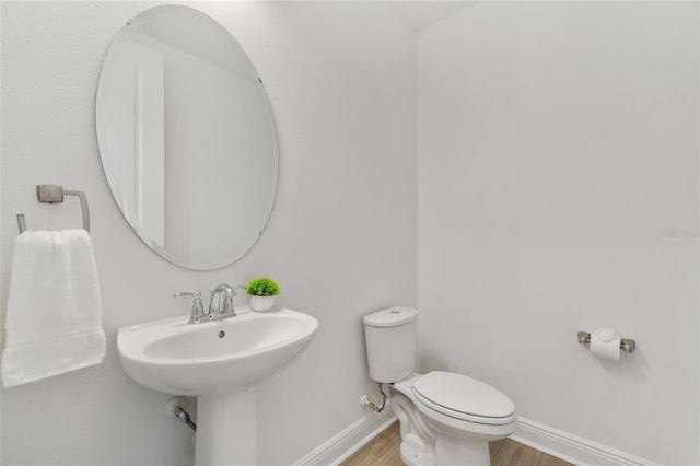 8484 Sperry St, Orlando, FL 32827 - bathroom featuring wood finished floors and toilet