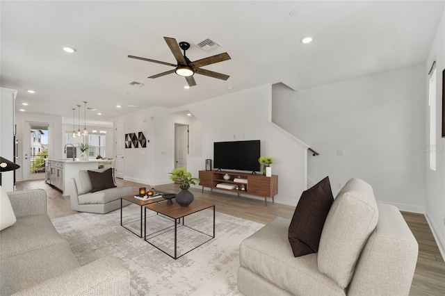 8484 Sperry St, Orlando, FL 32827 - living area with a chandelier, ceiling fan, recessed lighting, and light wood-style flooring