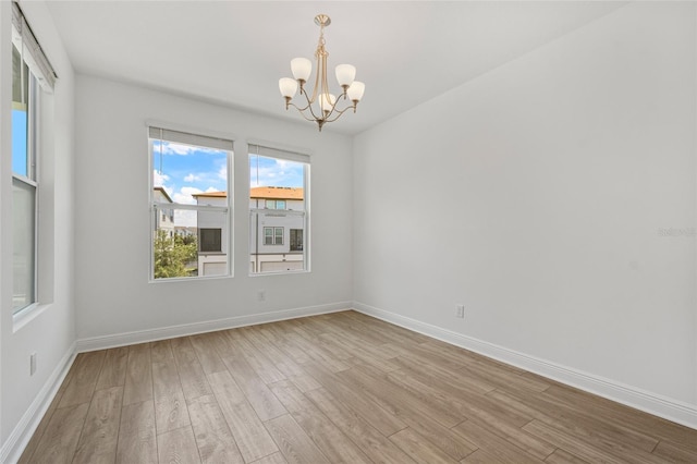 8484 Sperry St, Orlando, FL 32827 - unfurnished room featuring a chandelier, light wood finished floors, and healthy amount of natural light
