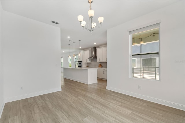 8484 Sperry St, Orlando, FL 32827 - unfurnished living room featuring a chandelier, light wood-type flooring, and recessed lighting