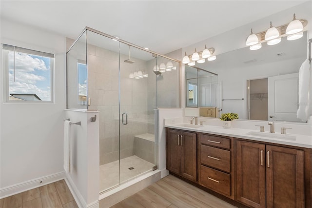 8484 Sperry St, Orlando, FL 32827 - full bathroom featuring a stall shower, double vanity, and wood finished floors