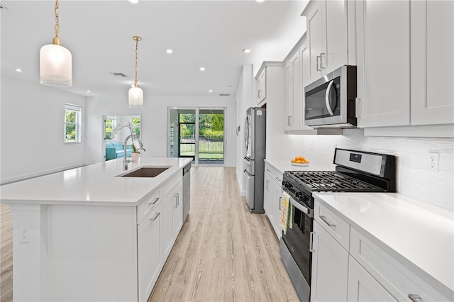11695 SW Viridian Blvd, Port St Lucie, FL 34987 - kitchen with stainless steel appliances, healthy amount of natural light, light wood-style flooring, light countertops, and recessed lighting