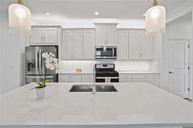 11695 SW Viridian Blvd, Port St Lucie, FL 34987 - kitchen featuring appliances with stainless steel finishes, light countertops, tasteful backsplash, recessed lighting, and hanging light fixtures