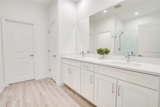 11695 SW Viridian Blvd, Port St Lucie, FL 34987 - bathroom with a stall shower, double vanity, wood finished floors, and recessed lighting