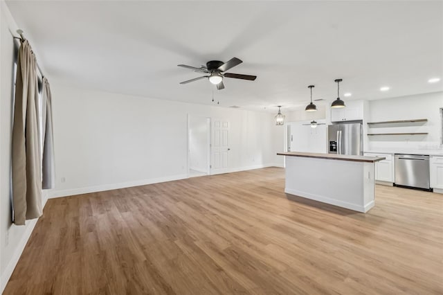 1320 E Lombardy Dr, Deltona, FL 32725 - unfurnished living room with a ceiling fan, recessed lighting, and light wood-style flooring