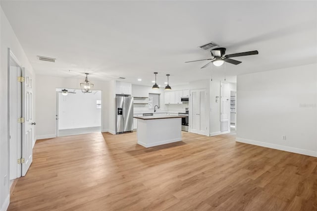 1320 E Lombardy Dr, Deltona, FL 32725 - kitchen featuring stainless steel fridge, ceiling fan, open floor plan, and recessed lighting