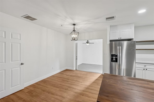 1320 E Lombardy Dr, Deltona, FL 32725 - unfurnished dining area featuring light wood-style floors, a chandelier, a ceiling fan, and recessed lighting