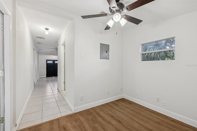 1320 E Lombardy Dr, Deltona, FL 32725 - spare room with a ceiling fan, electric panel, and light wood finished floors
